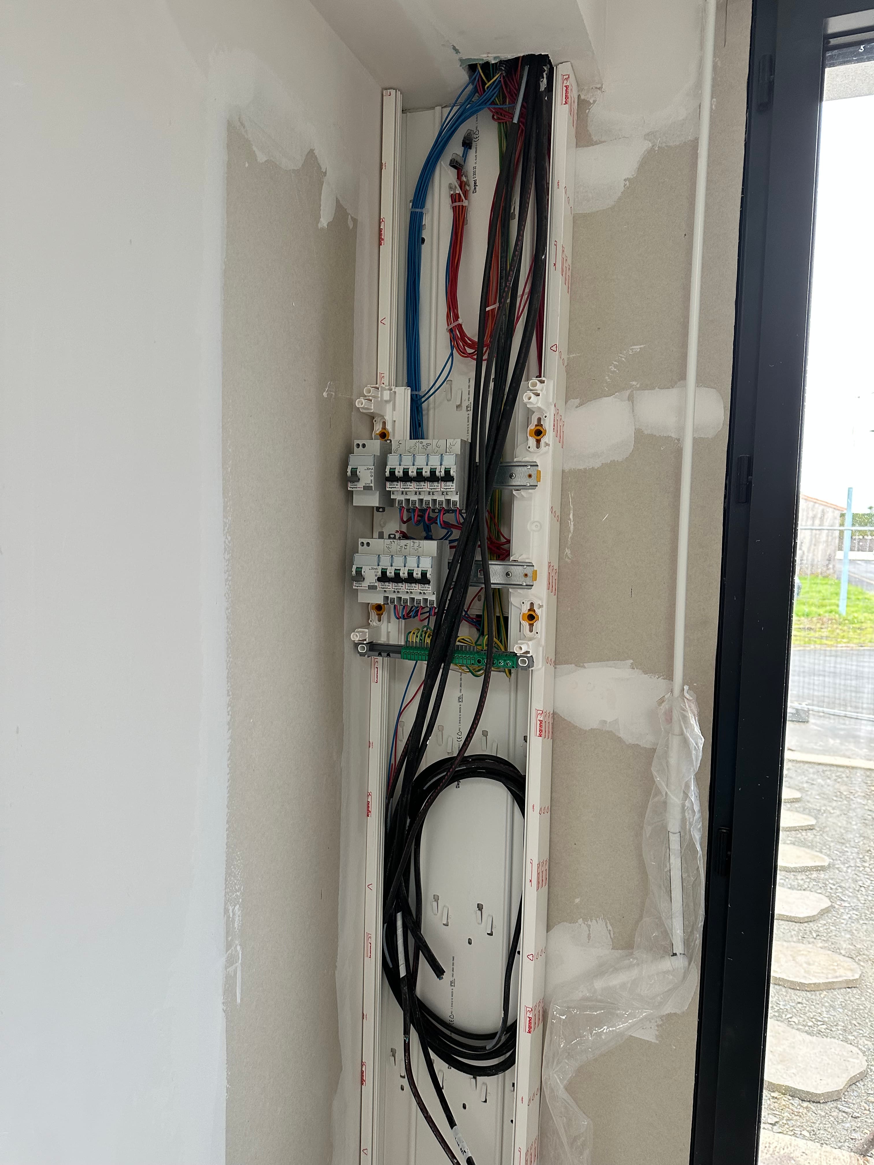 Tableau électrique encastré en cours d'installation
